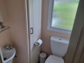 A bathroom with a sink and toilet at Chalet Sleeps 6 swimming pool Thorness Bay