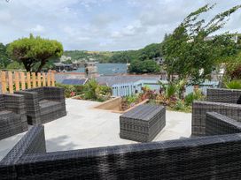 A garden with outdoor seating and water view at The Slipway Fowey Harbour with Garden Fowey