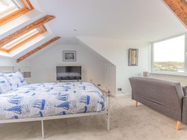 A bedroom with a bed and a tv at The Slipway Fowey Harbour with Garden in Fowey
