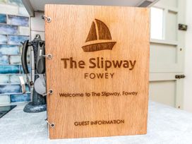 A wooden sign with guest information at The Slipway Fowey Harbour with Garden in Fowey