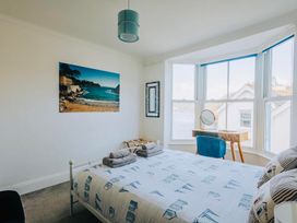 A bedroom with a bed and a mirror at The Slipway Fowey Harbour with Garden Fowey