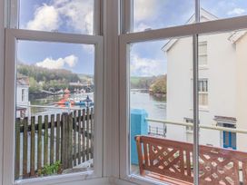 A view from a window showing a river and houses at The Slipway Fowey Harbour with Garden in Fowey
