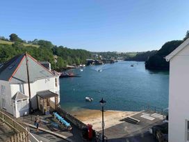 A house by the water with boats and a pier at The Slipway Fowey Harbour with Garden Fowey