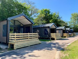 A row of cabins with wooden decking and a pathway at Selfcatering Lodge Inverness Sleeps 4 Inverness