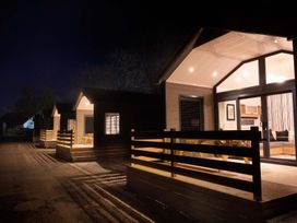 Three lodges with balconies and lights at Selfcatering Lodge Inverness Sleeps 4 in Inverness