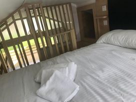A bedroom with a bed and towels at Selfcatering Lodge Inverness Sleeps 4 Inverness