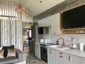 A kitchen with appliances and seating area at Selfcatering Lodge Inverness Sleeps 4 in Inverness