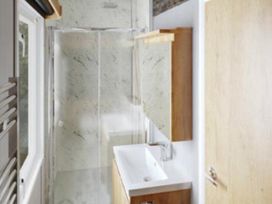 A bathroom with shower and sink at Selfcatering Lodge Inverness Sleeps 4