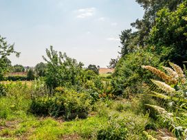 A garden with trees and bushes at Alpaca Farm Valley Views Sleeps 4 Parking Pets in Husthwaite
