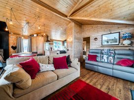 A living room with a sofa and dining area at Alpaca Farm Valley Views Sleeps 4 Parking Pets Husthwaite
