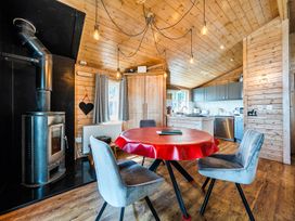 A kitchen with a stove and a round table at Alpaca Farm Valley Views Sleeps 4 Parking Pets in Husthwaite