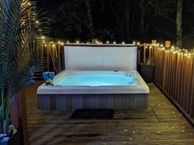 A hot tub on a deck surrounded by lights at Felmoor Park Northumberland Lodge with Hot Tub Felmoor Park near Felton