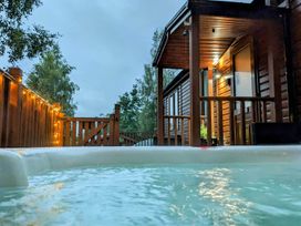 A hot tub on a wooden deck at Felmoor Park Northumberland Lodge with Hot Tub near Felton