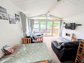 A living room with a sofa, dining table and television at Felmoor Park Northumberland Lodge with Hot Tub, Felmoor Park near Felton