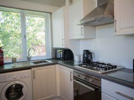 A kitchen with a sink, gas stove, and washing machine at Felmoor Park Northumberland Lodge with Hot Tub Felmoor Park near Felton