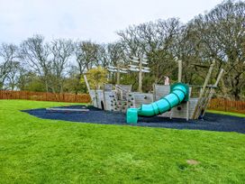 A playground with a pirate ship structure and slide at Felmoor Park near Felton