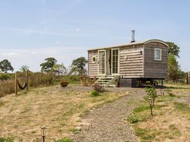 A tiny house with steps and outdoor seating at Cosy Luxury Owls Roost Hut with Private Hot Tub, Little Deptford Farm near Umberleigh