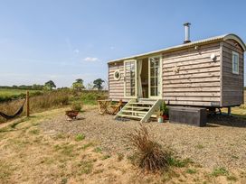A tiny house with steps and a fire pit at Cosy Luxury Owls Roost Hut with Private Hot Tub Little Deptford Farm near Umberleigh