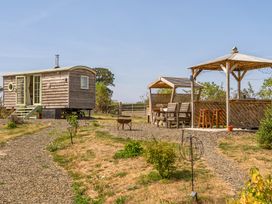 An outdoor area with a tiny house and gazebo at Cosy Luxury Owls Roost Hut with Private Hot Tub Little Deptford Farm near Umberleigh