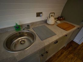 A kitchen with a sink and kettle at 1Bed pod cabin in beautiful surroundings Wrexham