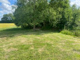 An outdoor space with a tree and grassy area at 1Bed pod cabin in beautiful surroundings Wrexham