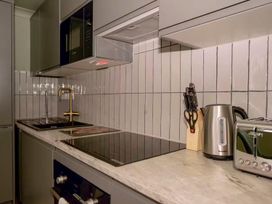 A kitchen with a microwave, electric kettle, toaster, and knife block at 1 Bedroom Apartment Sleeps 2 Pets Welcome, Carbis Bay