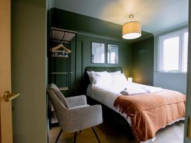 A bedroom with a bed and chair at 1 Bedroom Apartment Sleeps 2 Pets Welcome Carbis Bay