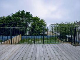 An outdoor area with wooden decking and a view of trees and grass at 1 Bedroom Apartment Sleeps 2 Pets Welcome Carbis Bay