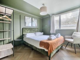 A bedroom with a bed and chair at 1 Bedroom Apartment Sleeps 2 Pets Welcome in Carbis Bay