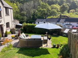 A garden with a seating area and umbrella at a property in the countryside