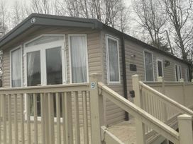 A caravan with a deck and steps at Charming Caravan in beautiful Seton Sands Cockenzie And Port Seton