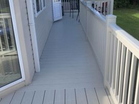 A porch area with decking and a door at Charming Caravan in beautiful Seton Sands, Cockenzie And Port Seton