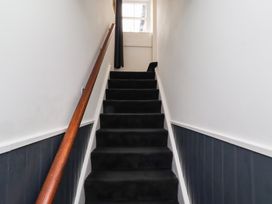 A staircase with a handrail at Cooper's Cottage in Morpeth