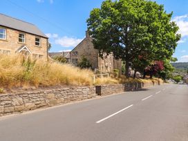 A street scene with houses and a tree at Cooper's Cottage in Morpeth