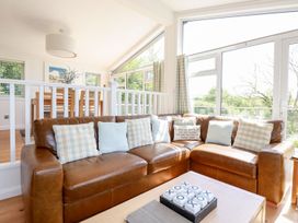 A living room with a sofa and coffee table at 4 Tree Tops in Liskeard