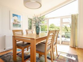 A dining room with a table and chairs at 4 Tree Tops in Liskeard
