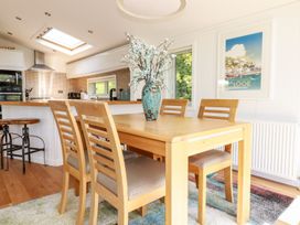 A dining room with a table and chairs at 4 Tree Tops in Liskeard