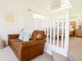 A bedroom with a sofa and bed at 4 Tree Tops in Liskeard