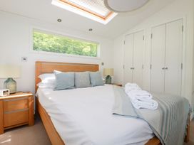 A bedroom with a bed and bedside table at 4 Tree Tops Liskeard