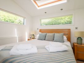A bedroom with a bed and bedside table at 4 Tree Tops Liskeard