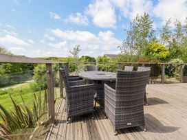 An outdoor area with a table and chairs at 4 Tree Tops in Liskeard