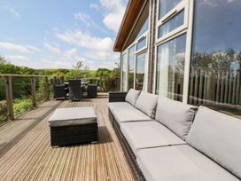 An outdoor patio with a sofa and dining set at 4 Tree Tops in Liskeard