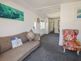 A living room with a sofa and armchair at Harbourside Retreat in Looe