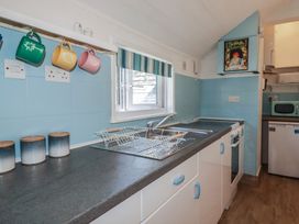 A kitchen with a sink and cooking range at Harbourside Retreat in Looe