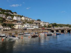 A view of boats in water and houses along a hillside at Harbourside Retreat in Looe