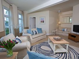 A living room with sofas and a coffee table at 4 The Salcombe in Salcombe
