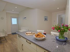 A kitchen with a counter and a bowl of croissants at 4 The Salcombe in Salcombe