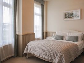 A bedroom with a bed and bedside table at 4 The Salcombe in Salcombe