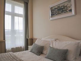 A bedroom with a bed and window at 4 The Salcombe in Salcombe