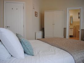 A bedroom with a bed and wardrobe at 4 The Salcombe in Salcombe